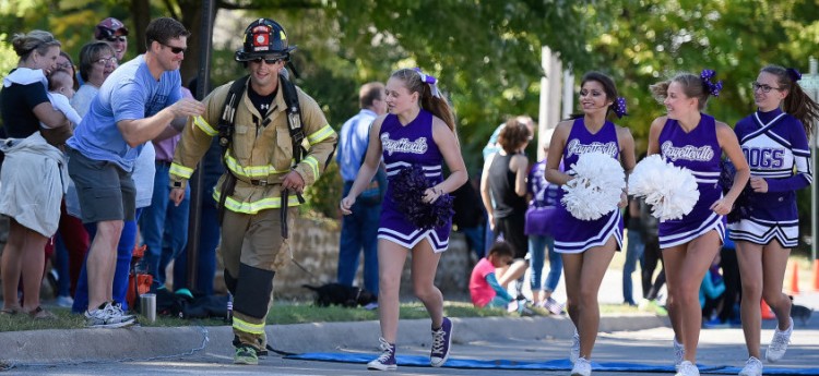 Spectators and FHS cheerleaders motivate a firefighter during the hardest portion of the marathon